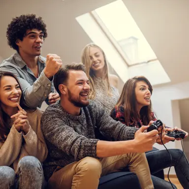 A group of young people play video games together.